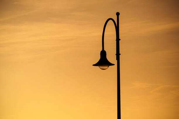 istock street lamp on sunset sky background 1162974472