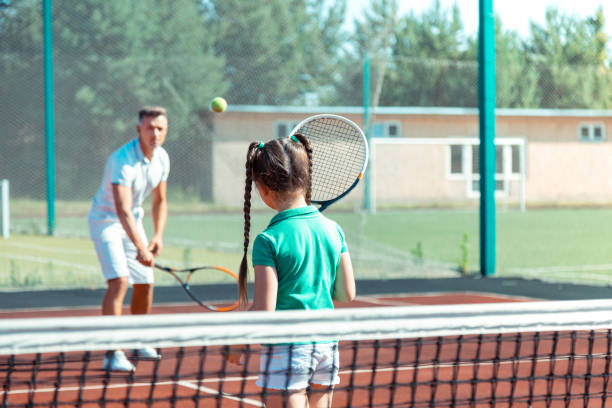 istock Daughter feeling involved in playing tennis with father 1162974843