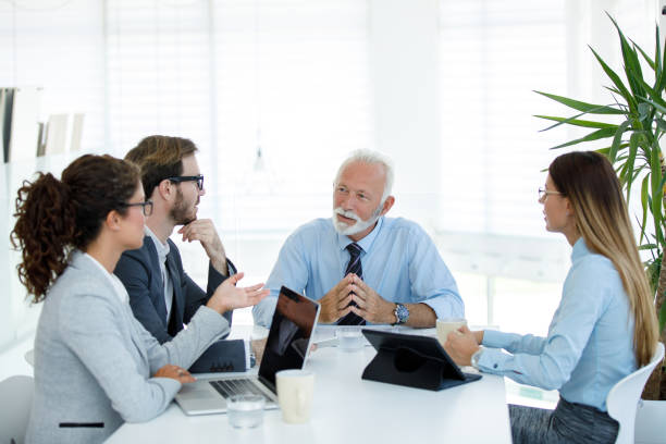 istock Young business people cooperating with experienced colleague 1162975123