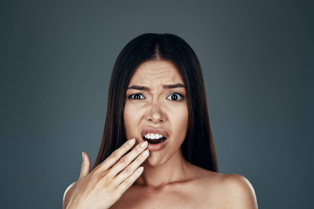 istock Oh no! Confused young Asian woman making a face and looking at camera while standing against grey background 1162978791
