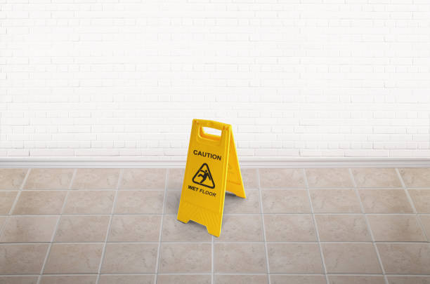 istock Yellow wet floor slippery sign in an empty room 1162978991
