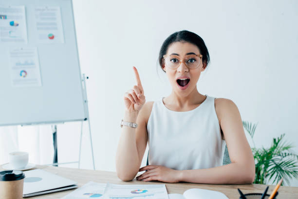 istock excited latin businesswoman showing idea gesture while looking at camera 1162979141