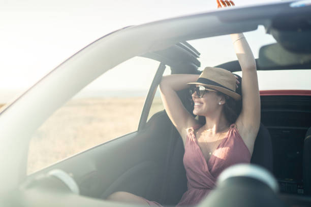 istock Woman in a car looking away through window 1162980259
