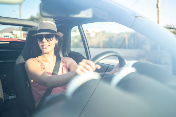 istock Happy woman driving car, enjoying vacations 1162980263