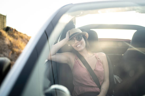 istock Woman in a car looking away through window 1162980272