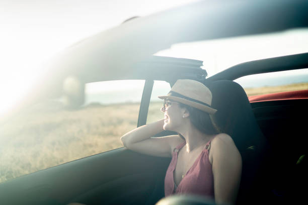 istock Woman in a car looking away through window 1162980313