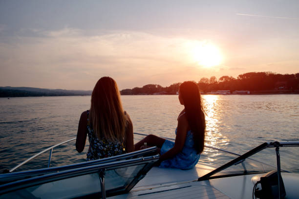 Boat sunset, two girls are enjoying