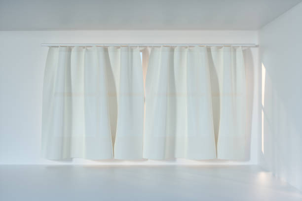 istock An empty room with sunshine come through the curtain, 3d rendering. 1162985371