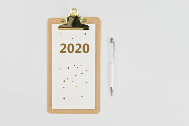 istock Yearly calendar 2020 clipboard notebook and pen on white 1162986721
