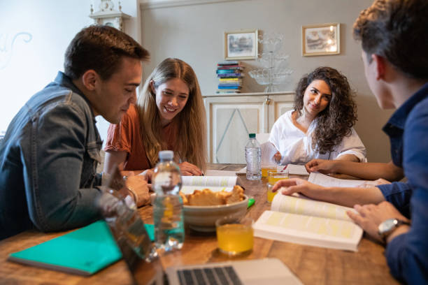 istock Studying and cooperation - Group of mixed friends sharing a studio to prepare an university exam 1162987972