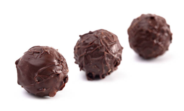 istock Dark Chocolate Truffles Filled with Caramel Isolated on a White Backgroun 1162988403