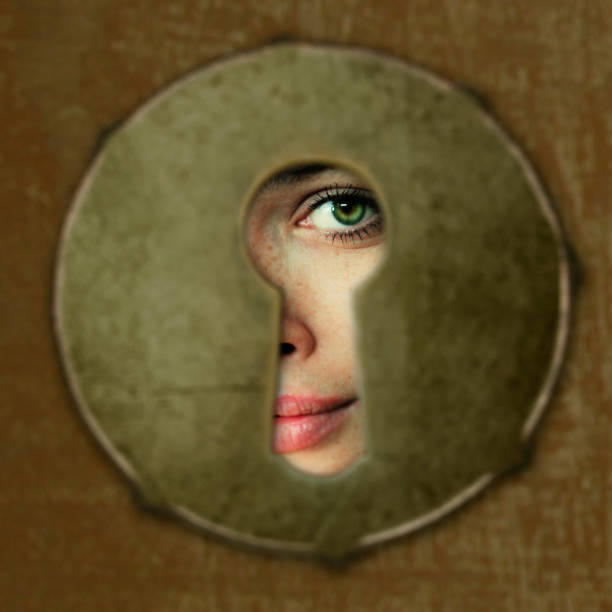 eye in key hole eye in key hole woman spying through a keyhole stock pictures, royalty-free photos & images