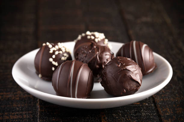 istock A Moody Image of Chocolate Truffles on a Rustic Wooden Table 1162992175