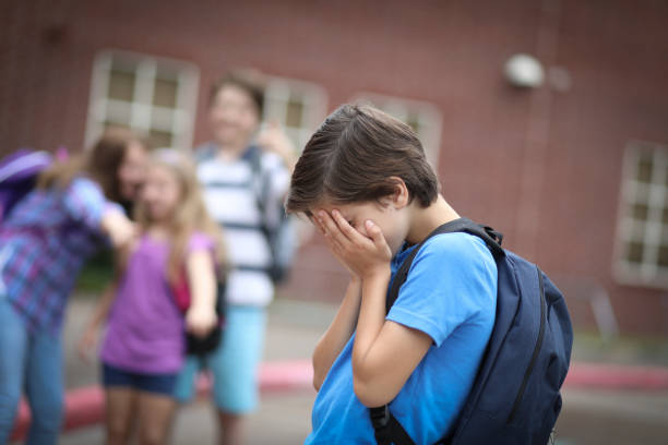 istock Elementary age boy being bullied at school. 1162995514