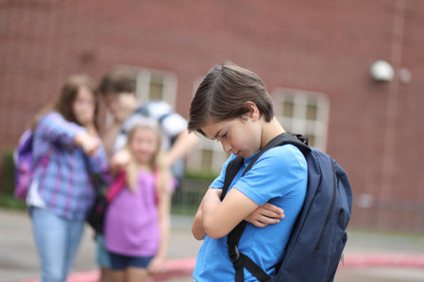 istock Elementary age boy being bullied at school. 1162995526