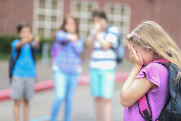istock Elementary age girl being bullied at school. 1162995553