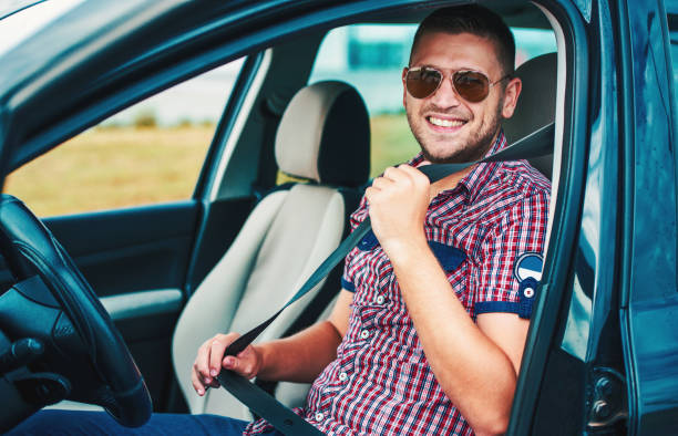 istock Drive safely. Man putting car seat belt before driving. Transportation concept 1162996140