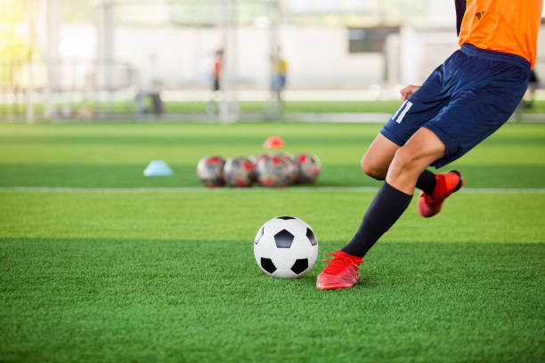 istock Soccer player speed run to shoot ball to goal on artificial turf. 1162996162