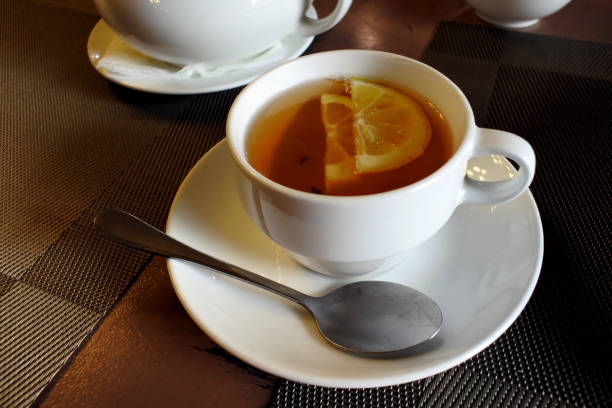 istock tea in a mug with a teaspoon and lemon 1162996431