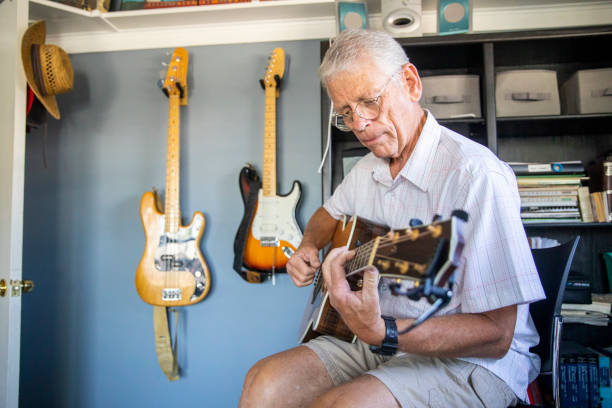 istock Senior Man Playing Guitar in his Studio 1162998560
