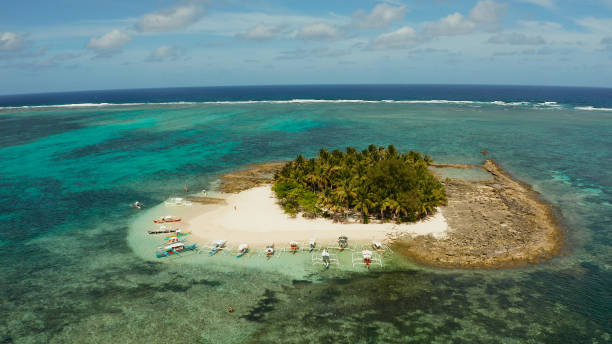 istock Tropical Guyam Island with a sandy beach and tourists 1162998911