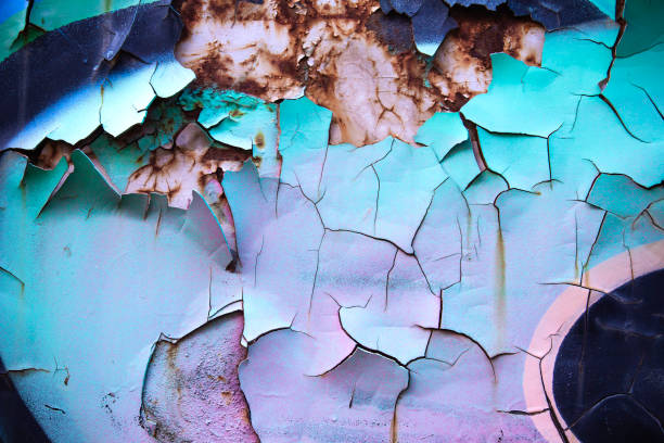 Old graffity detail on rusty wall Old rusty scrap metal with distressed cracked paint purple graffiti metallic wall stock pictures, royalty-free photos & images