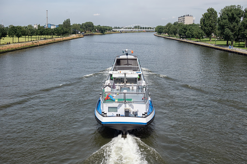 Large inland ship at Dutch Amsterdam Rijn canal sailing near city Utrecht