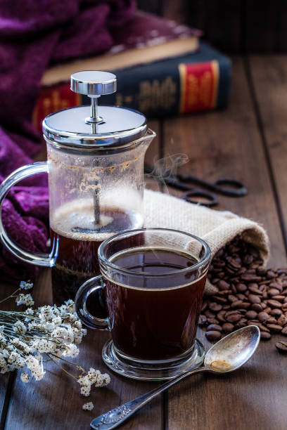 istock Coffee cup and french coffee maker on brown table 1163004268