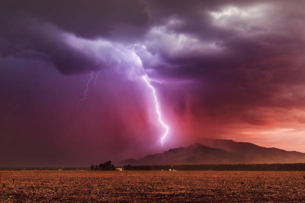 Lightning storm at sunset Lightning bolt strikes a mountain during a monsoon thunderstorm at sunset near Dragoon, Arizona. dragoon mountains photos stock pictures, royalty-free photos & images