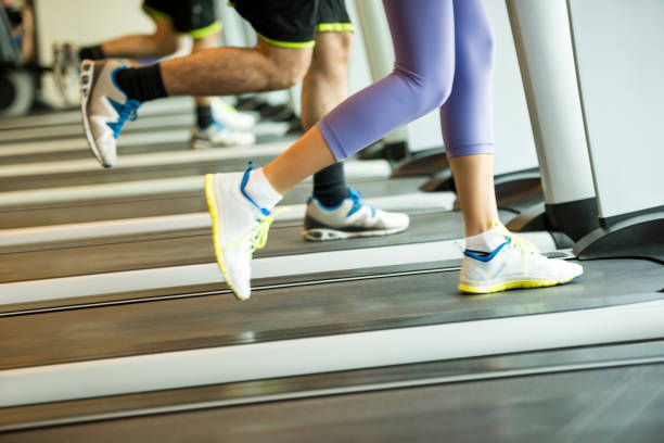 istock Couple exercising on treadmills in the gym 1163005198