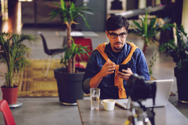 istock Man making live video about new his new app for android phones 1163007344