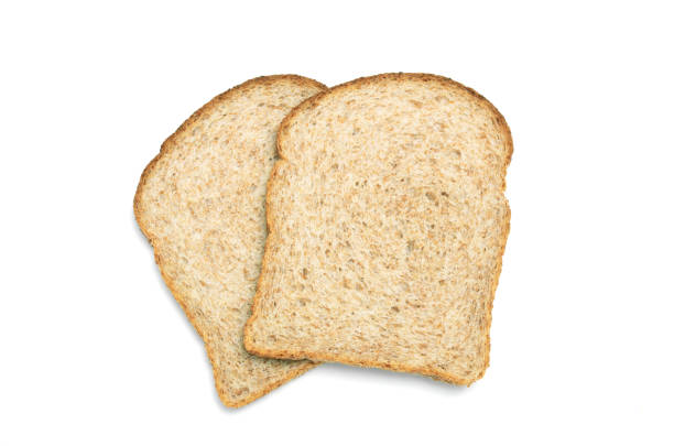 два ломтика цельножки коричневого �хлеба выстрелил сверху на белом фоне - bread isolated white portion стоковые фото и изображения
