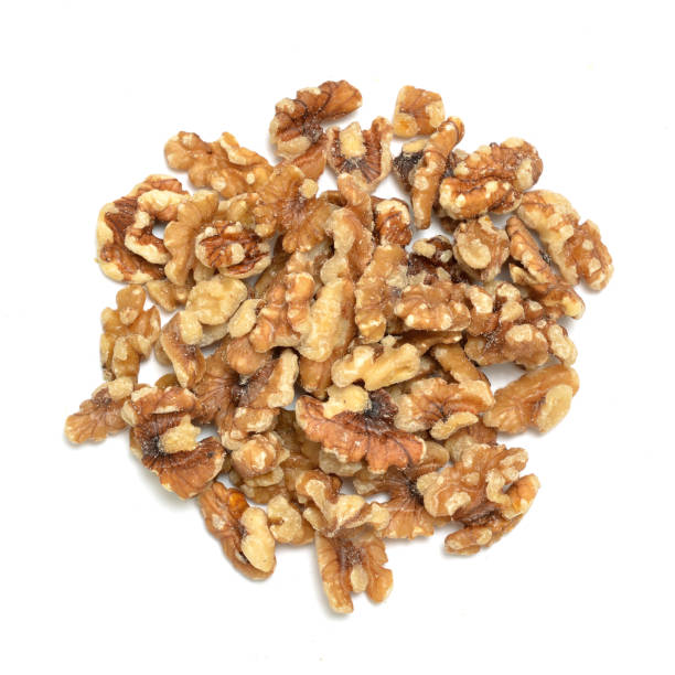istock Pile of broken walnut pieces on white shot from above 1163008957