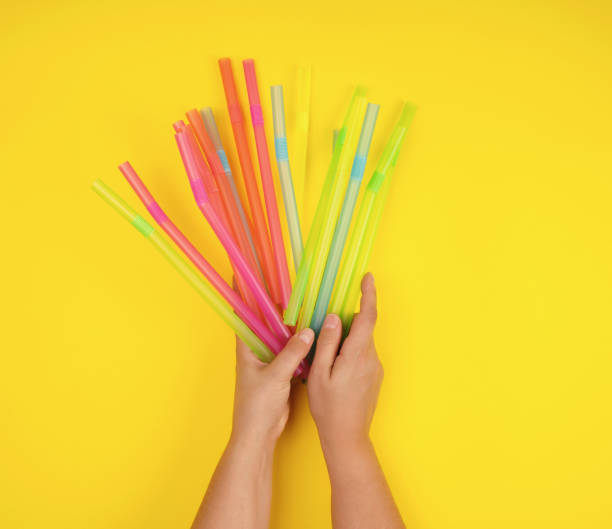 istock female hand holding multicolored plastic cocktail tubes 1163009022