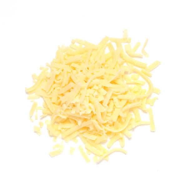 pile of grated cheddar cheese shot from above isolated on white background - grated imagens e fotografias de stock