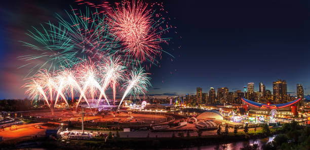 Calgary Stampede Fireworks Over City Skyline Firework display over the night sky with the Calgary downtown skyline in the backdrop during the annual Calgary Stampede festivities. stampeding photos stock pictures, royalty-free photos & images