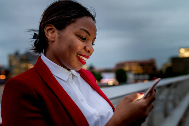 istock Businesswoman reading message on mobile phone 1163013057