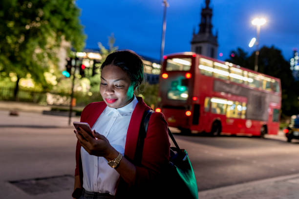 istock Businesswoman reading message on mobile phone 1163013058