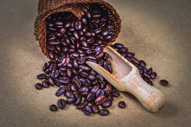 istock Wood spoon with coffee bean in sack bag on background. 1163013421
