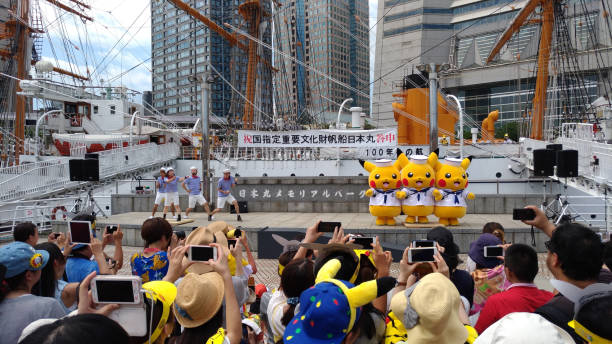 Yokohama, Japan - August 09, 2017 : Performer dressed as Pikachu performs during the Pikachu Outbreak! 2017 annual event. Pikachus suddenly appear and dance around the Nippon Maru park. A lot of people visit to enjoy the big annual event