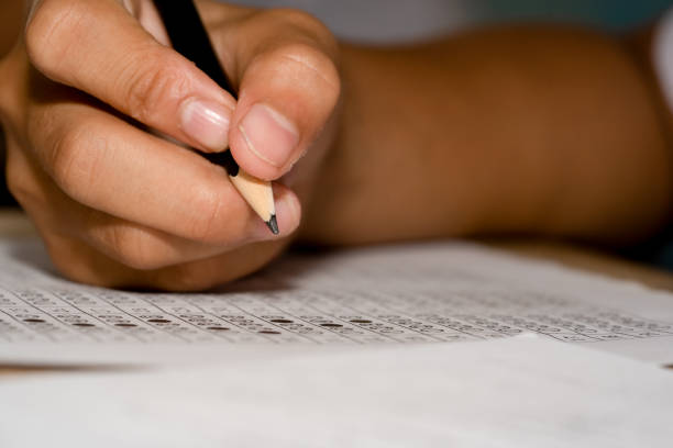 istock Pencil on hand of student holding to test examination 1163015263