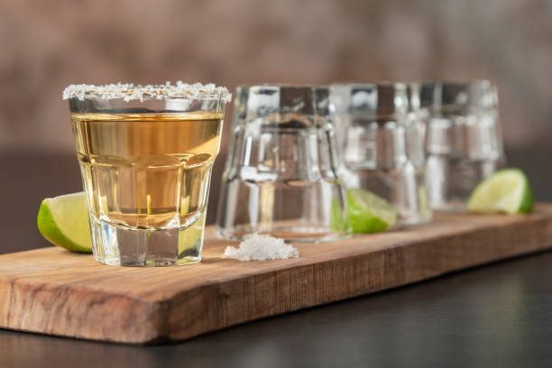 Tequila shots in a row. One more for the road tequila shot stock pictures, royalty-free photos & images