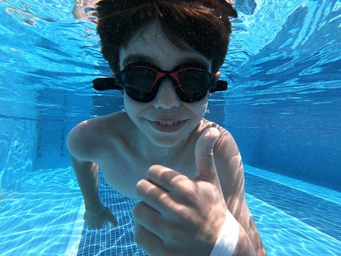 Happy boy in swimming pool