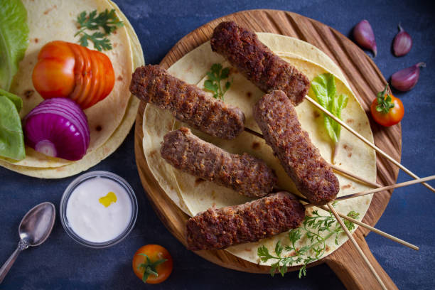 istock Lamb kebabs with pita bread, vegetables and yogurt sauce 1163020095