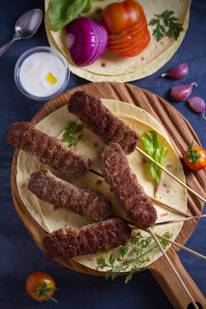 istock Lamb kebabs with pita bread, vegetables and yogurt sauce 1163020123