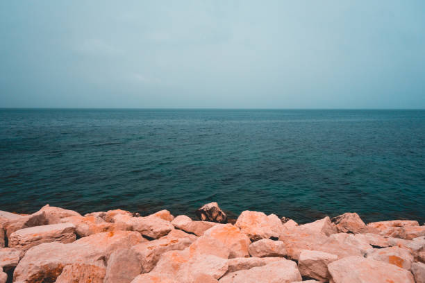 rocks at the ocean in cold colors