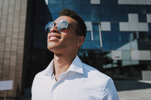 Joyful man is relaxing outdoors after good job in office