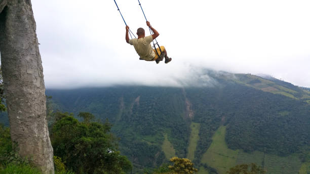 the swing at the end of the world located at casa del arbol, the tree house in banos, équateur - birds eye chilli photos et images de collection