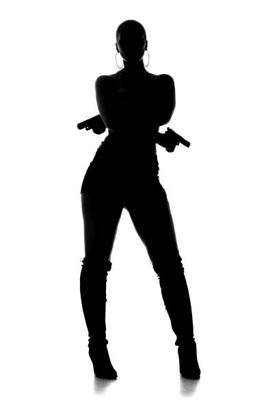 istock Sexy Female Gangster Silhouette 1163023611