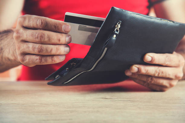 istock man hand credit card with wallet 1163024714